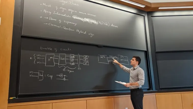 An instructor presenting diagrams at a chalkboard during a lecture